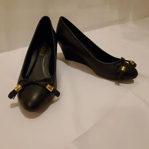 Black leather wedge pumps